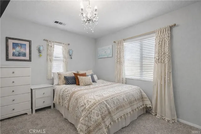 a bed room with a bed a couch and a window