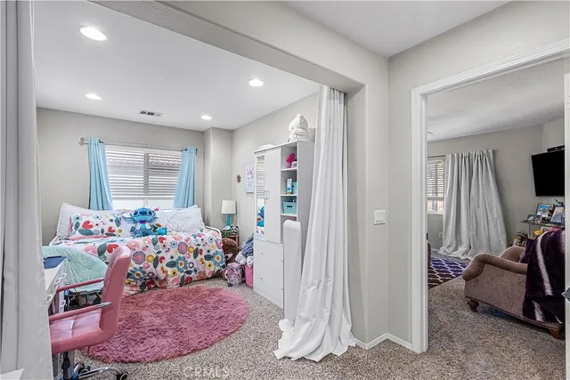 a view of a backyard with furniture and a garden