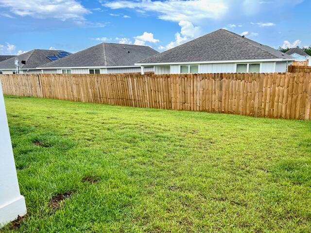 209 Laurel Hill Street Crestview, FL 32539 - Photo 16 of 24 a view of a backyard with a garden and plants