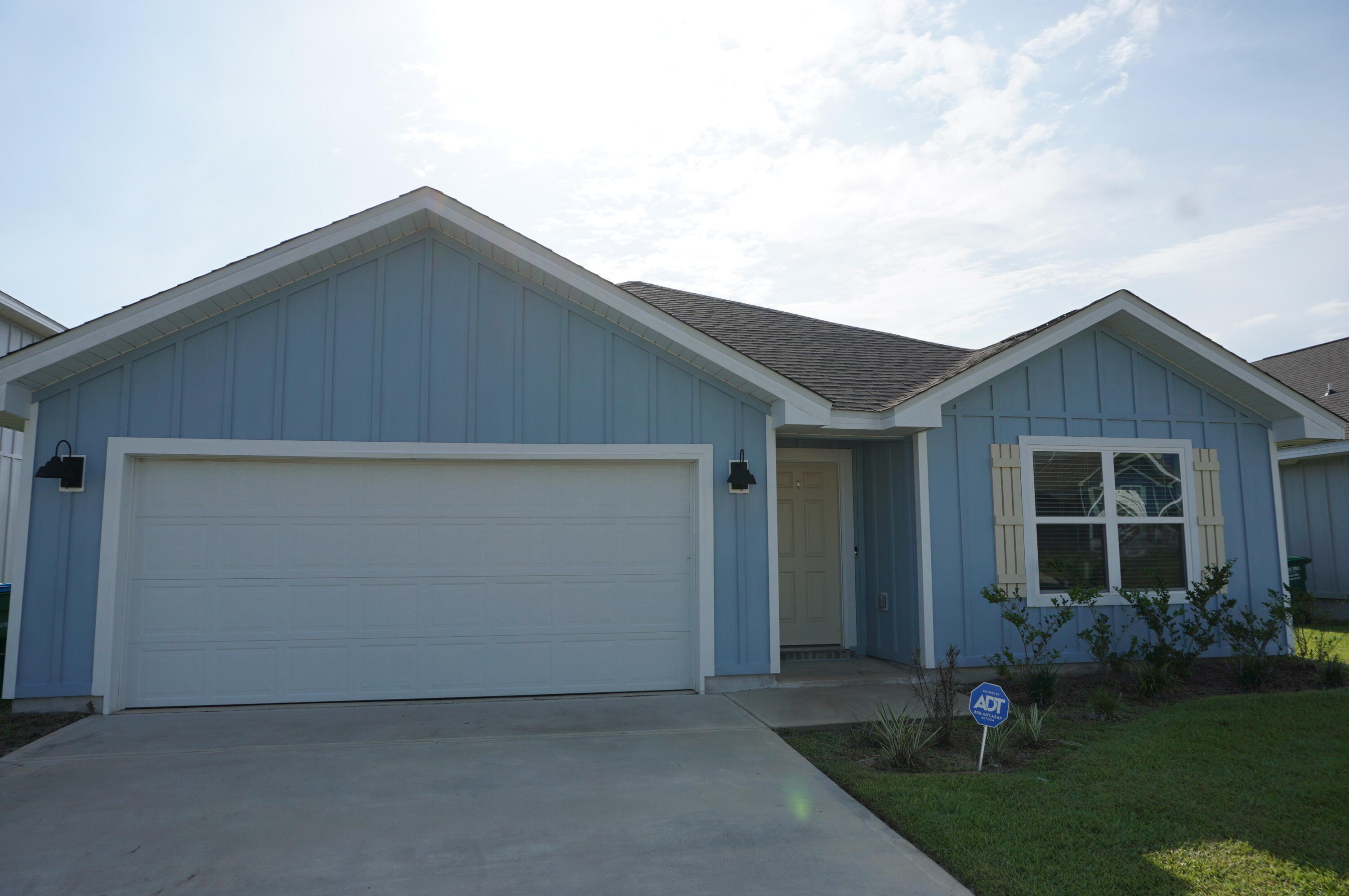 209 Laurel Hill Street Crestview, FL 32539 - Photo 21 of 24 a backyard of a house with lots of green space and plants