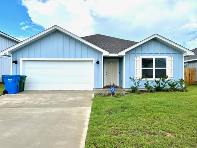 209 Laurel Hill Street Crestview, FL 32539 - Photo 3 of 24 a front view of house with yard and garage