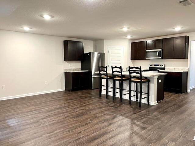 209 Laurel Hill Street Crestview, FL 32539 - Photo 6 of 24 a living room with stainless steel appliances furniture and a flat screen tv