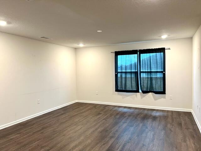 209 Laurel Hill Street Crestview, FL 32539 - Photo 8 of 24 a view of an empty room with wooden floor and fan