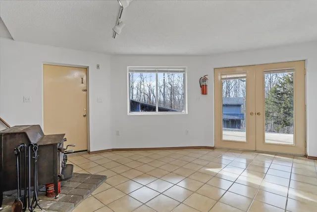 a bathroom with a granite countertop toilet a sink a mirror a bathtub and shower