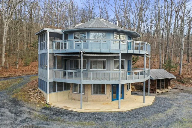 a aerial view of a house with a porch and furniture