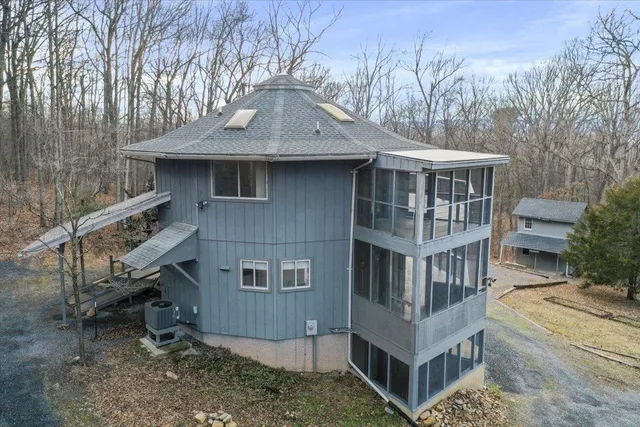 a backyard of a house with barbeque oven and seating space
