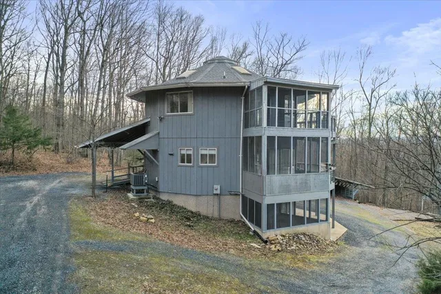 a wooden house with trees in front of it