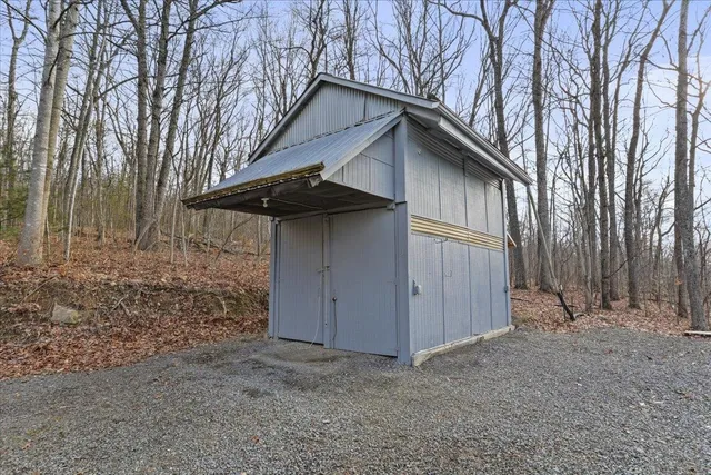 a view of a dry field with mountains in the background