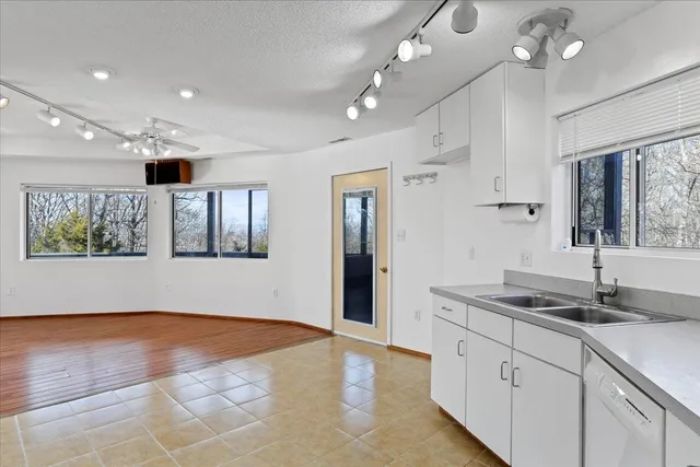 a large white kitchen with cabinets and a sink