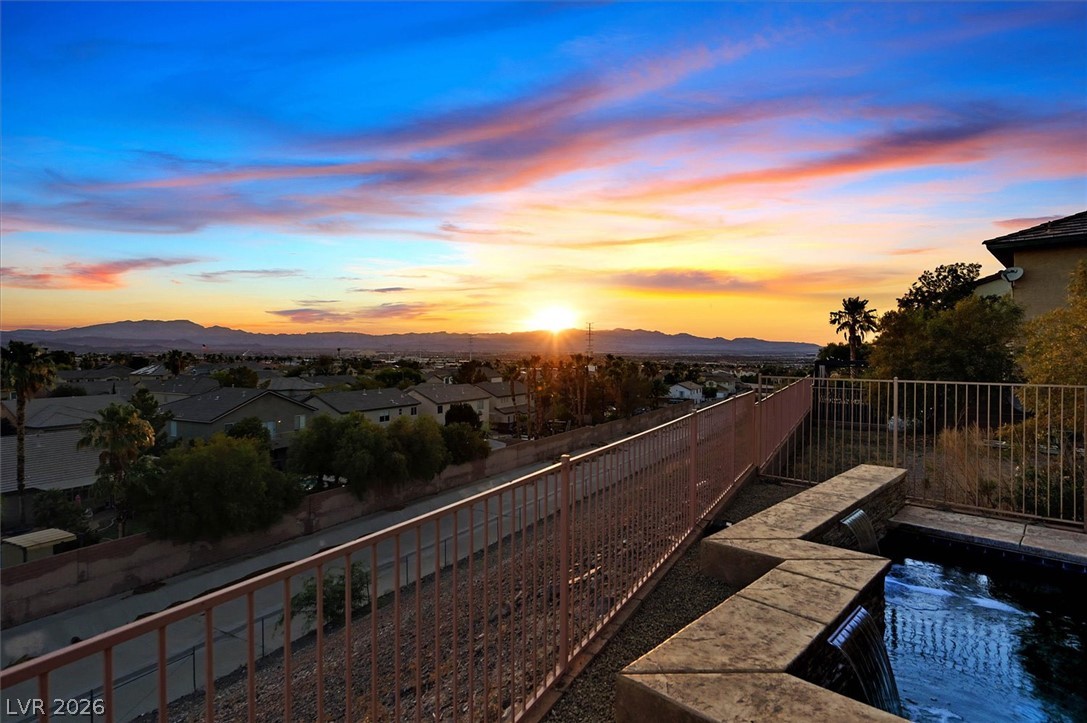 2447 Kaymin Ridge Road Henderson, NV 89052 - Photo 29 of 40 Distant mountains frame the horizon under colorful sunset skies from this elevated vantage point.