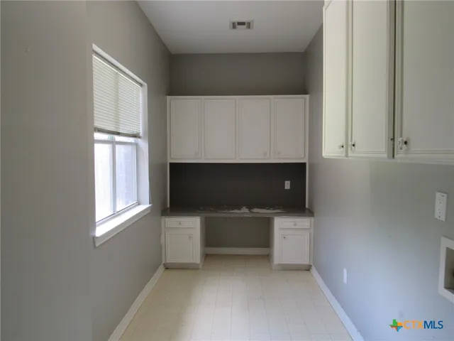 a kitchen with a cabinets and a microwave