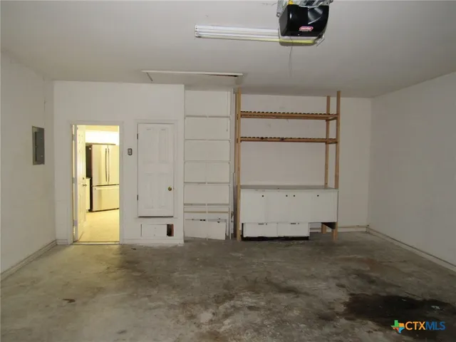 an empty room with cabinet and mirrors