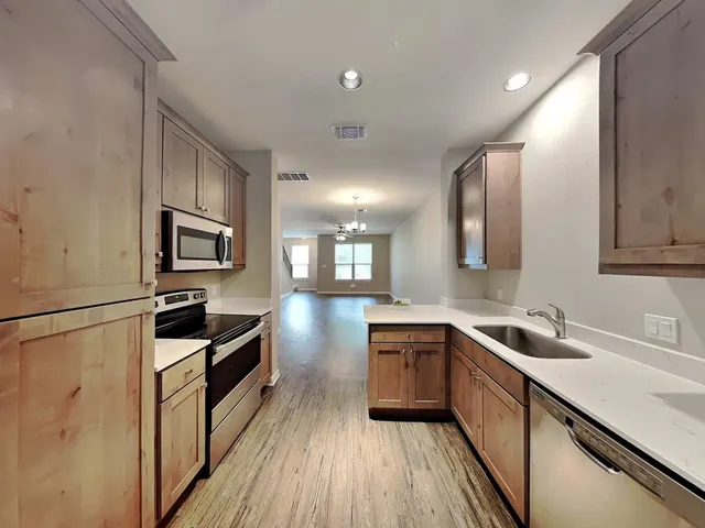 a kitchen with a stove and a refrigerator