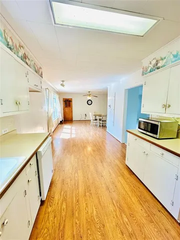 a view of a kitchen with wooden floor and a sink