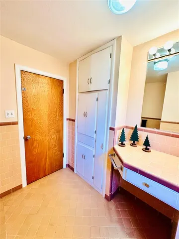 a spacious bathroom with a sink and a mirror