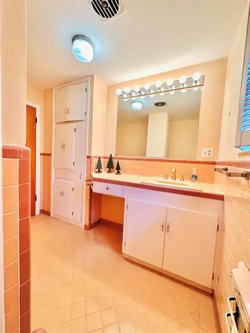 a spacious bathroom with a tub and a sink