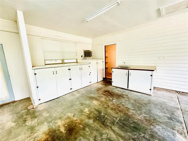 a view of empty room with wooden floor and windows