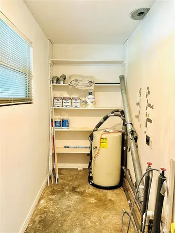 a view of a room with wooden floor and a window