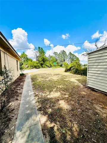 a view of a small house with a backyard
