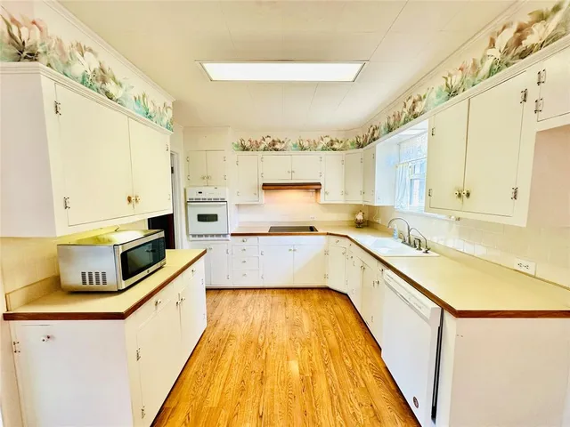 a large kitchen with a sink and cabinets