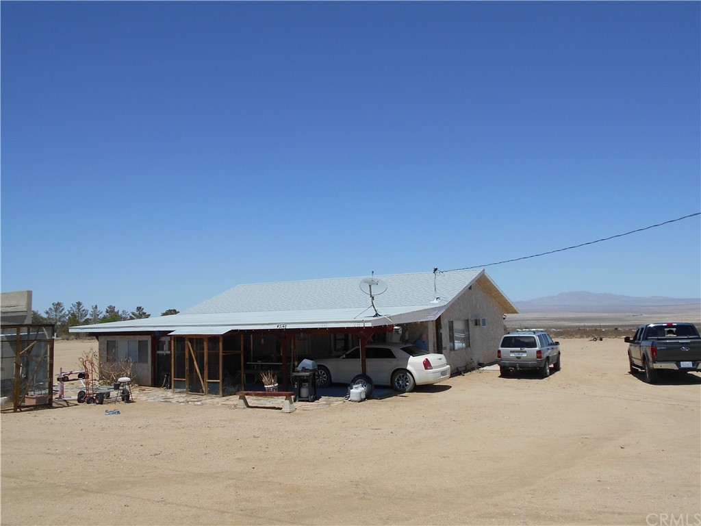 49148 Cholla Road Johnson Valley, CA 92285 - Photo 1 of 1 a car parked in front of a building