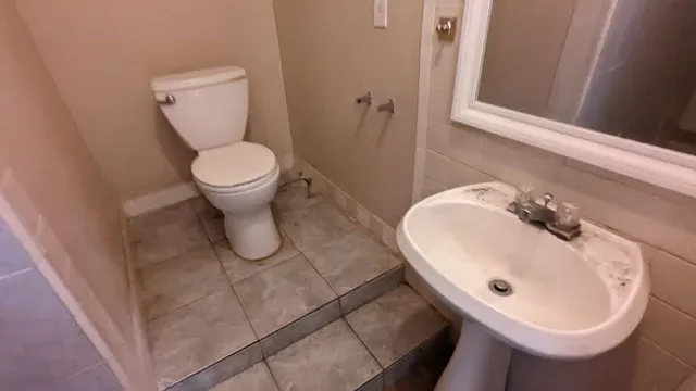 a bathroom with a shower sink and mirror