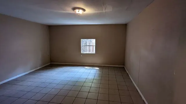 a view of an empty room and window