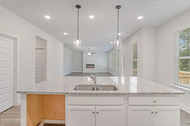 a bathroom with a granite countertop sink a large mirror and vanity