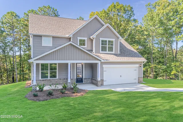a front view of house with a garden and patio