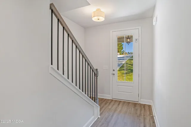 a view of an entryway with wooden floor