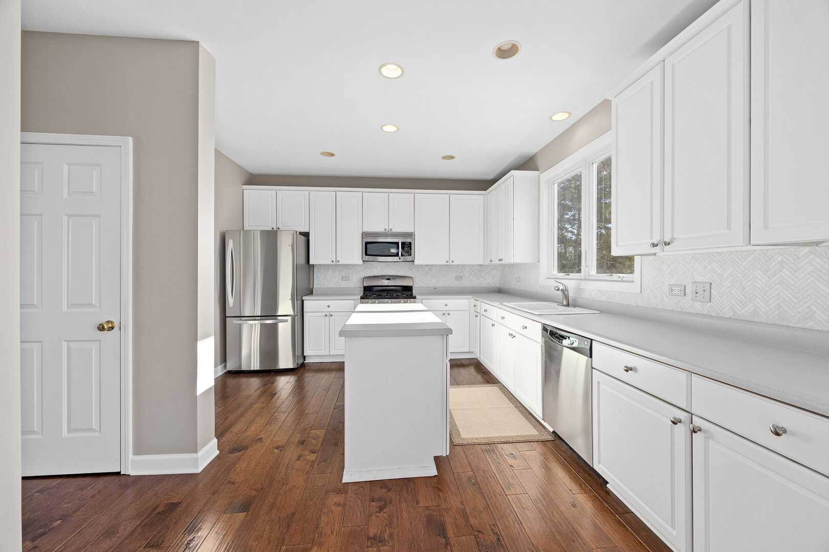 459 59th Street Lisle, IL 60532 - Photo 14 of 57 a kitchen with a refrigerator sink and cabinets