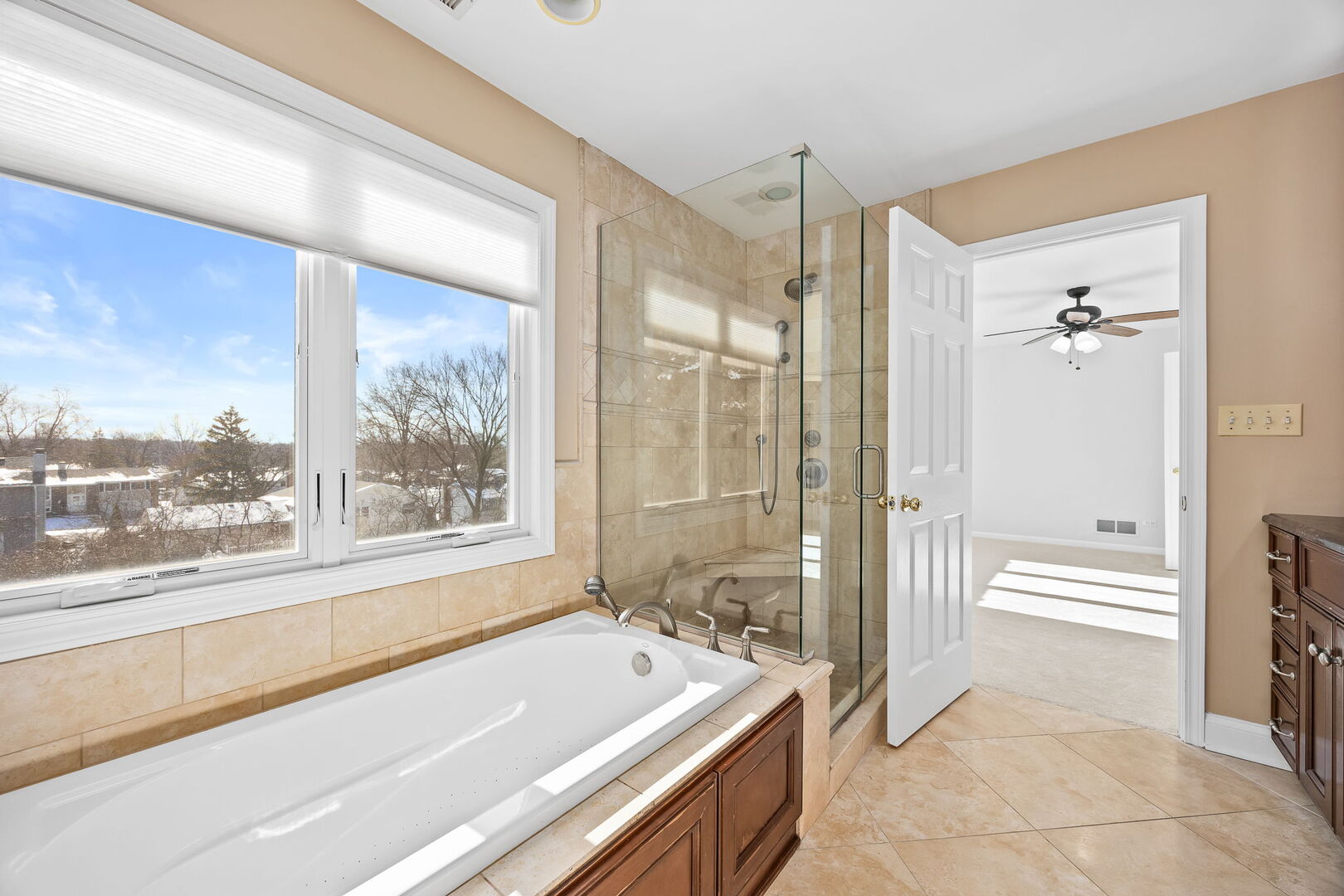 459 59th Street Lisle, IL 60532 - Photo 29 of 57 a bathroom with a tub a sink and a large window