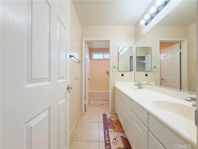 a spacious bathroom with a double vanity sink mirror and