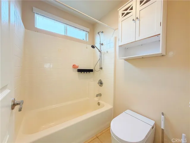 a bathroom with a toilet and a bathtub