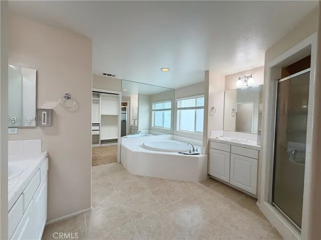 a spacious bathroom with a tub and a shower