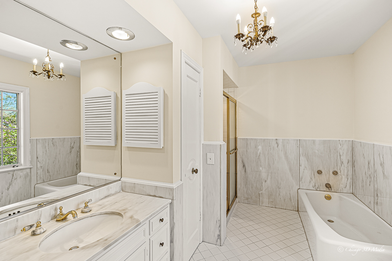 17 Longmeadow Road Winnetka, IL 60093 - Photo 18 of 46 a bathroom with a tub sink and mirror