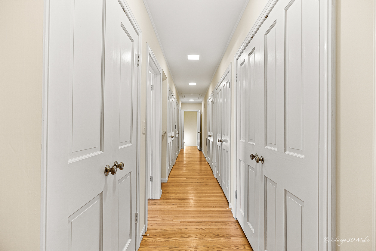 17 Longmeadow Road Winnetka, IL 60093 - Photo 21 of 46 a view of a hallway with wooden floor and staircase