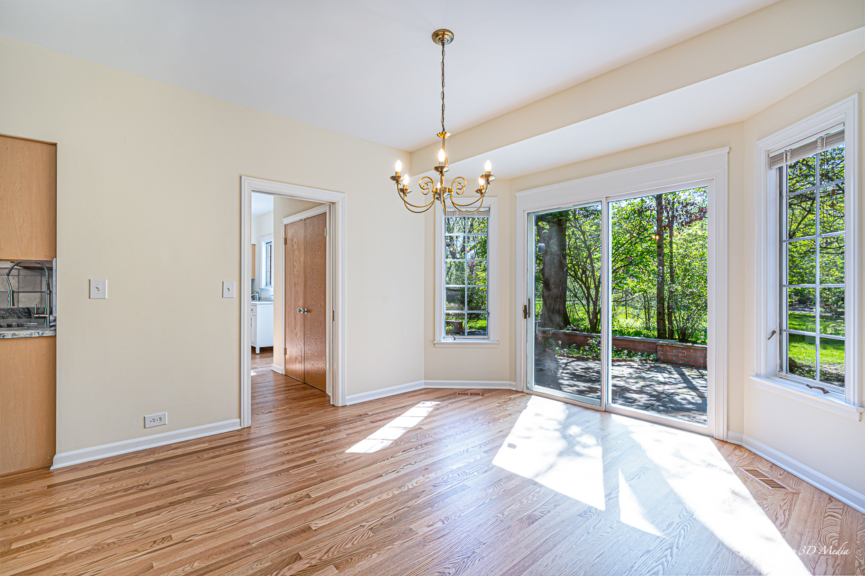 17 Longmeadow Road Winnetka, IL 60093 - Photo 23 of 46 a view of a room with wooden floor chandeliers and kitchen view