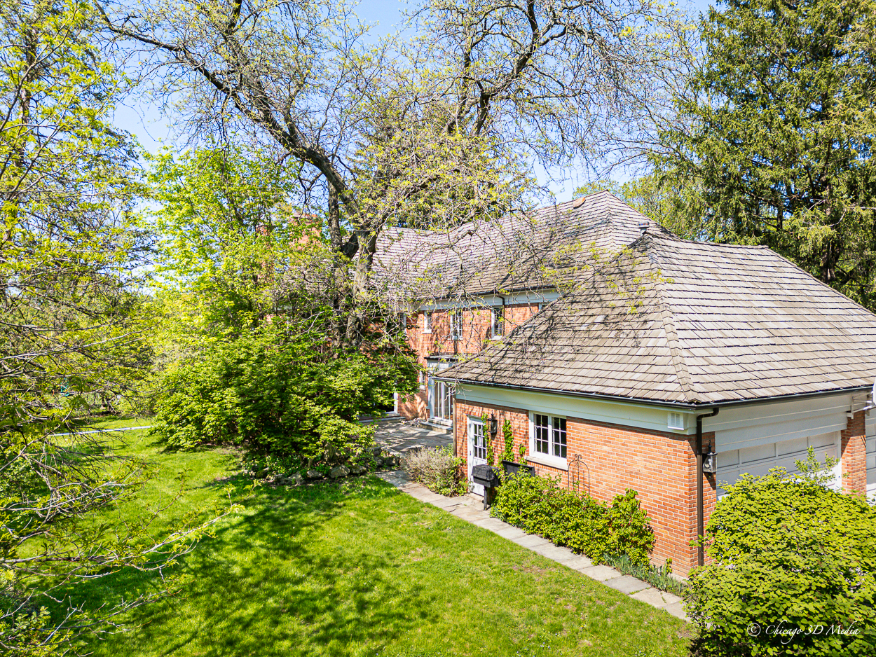 17 Longmeadow Road Winnetka, IL 60093 - Photo 26 of 46 a backyard of a house with plants and large trees