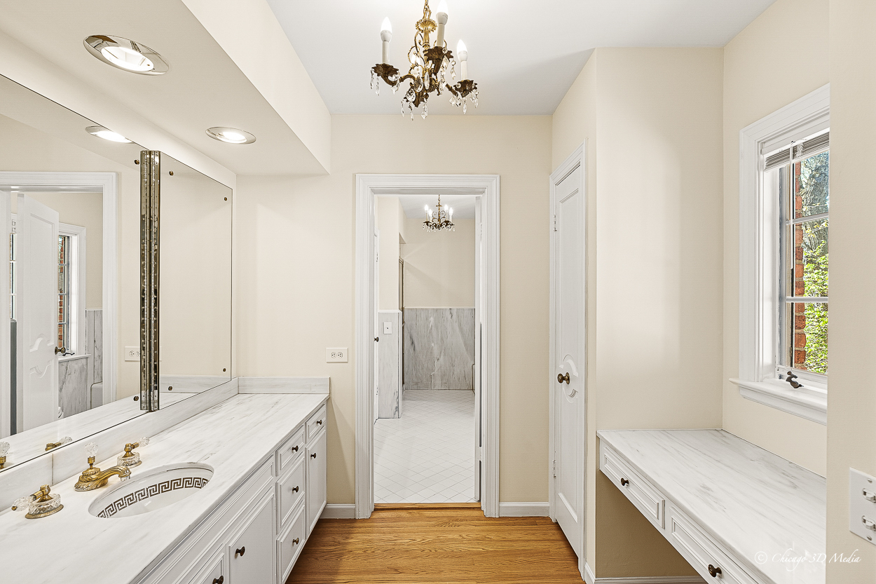 17 Longmeadow Road Winnetka, IL 60093 - Photo 37 of 46 a bathroom with a tub sink and mirror