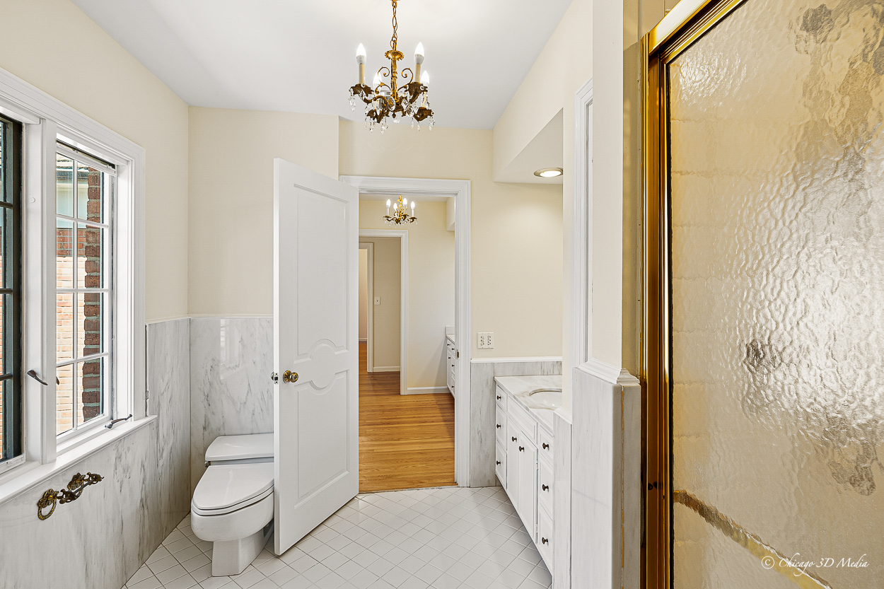 17 Longmeadow Road Winnetka, IL 60093 - Photo 38 of 46 a bathroom with a granite countertop sink a toilet and shower