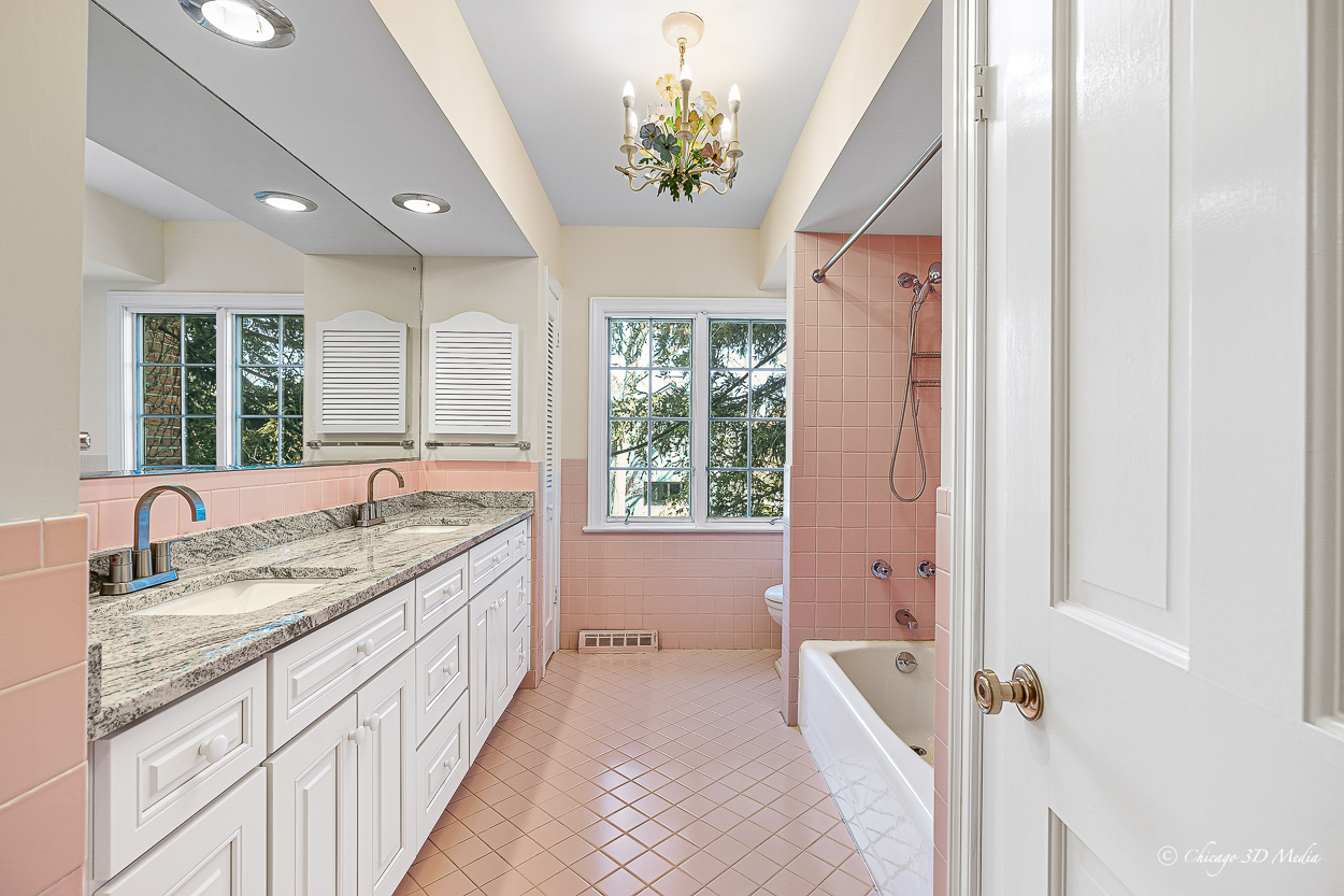 17 Longmeadow Road Winnetka, IL 60093 - Photo 39 of 46 a bathroom with a granite countertop sink a large mirror a bathtub and next to a window
