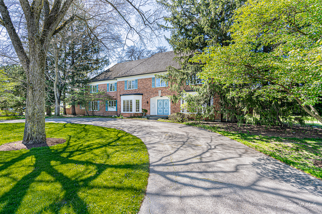 17 Longmeadow Road Winnetka, IL 60093 - Photo 45 of 46 a front view of a house with a yard table and chairs