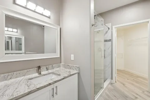 a bathroom with a granite countertop sink and a mirror