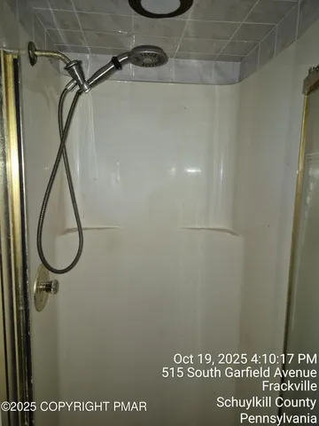 a bathroom with a sink a mirror and a shower