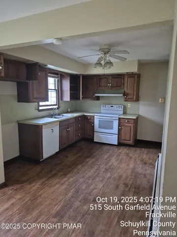 a view of a bathroom with a sink a mirror and a shower