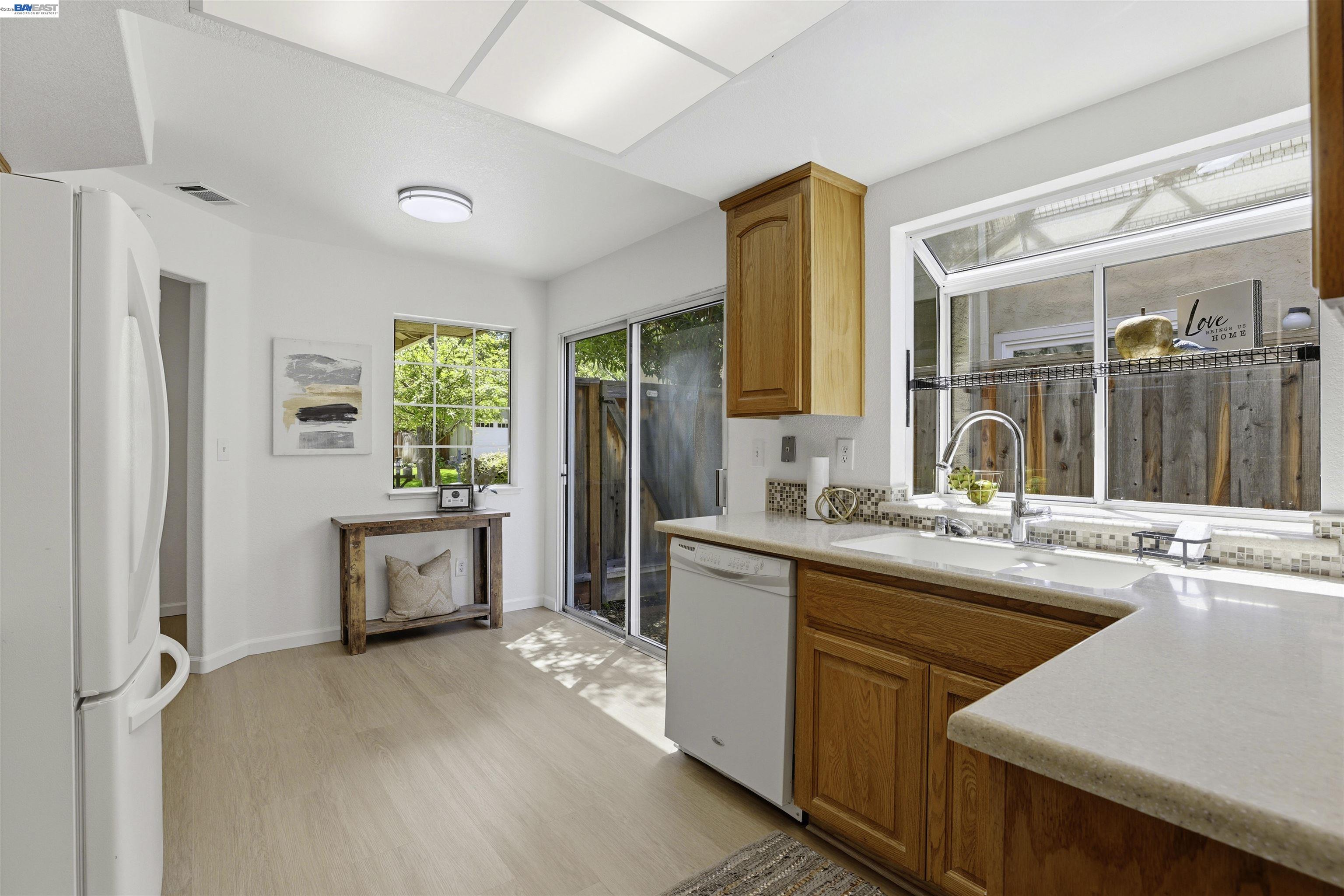 4161 Garibaldi Place Pleasanton, CA 94566 - Photo 16 of 47 a kitchen with kitchen island a sink a stove and a refrigerator
