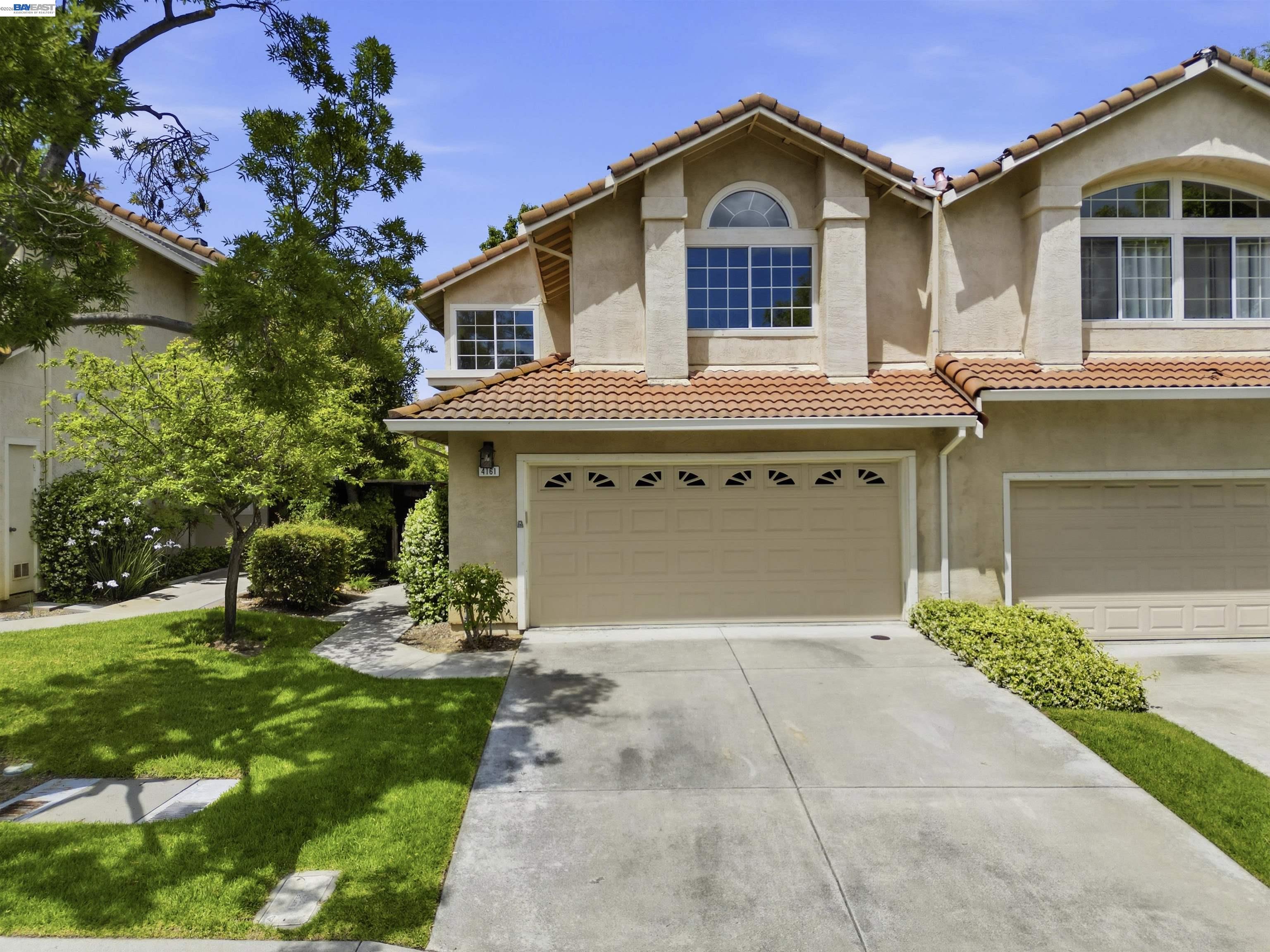 4161 Garibaldi Place Pleasanton, CA 94566 - Photo 3 of 47 a front view of a house with a yard and garage