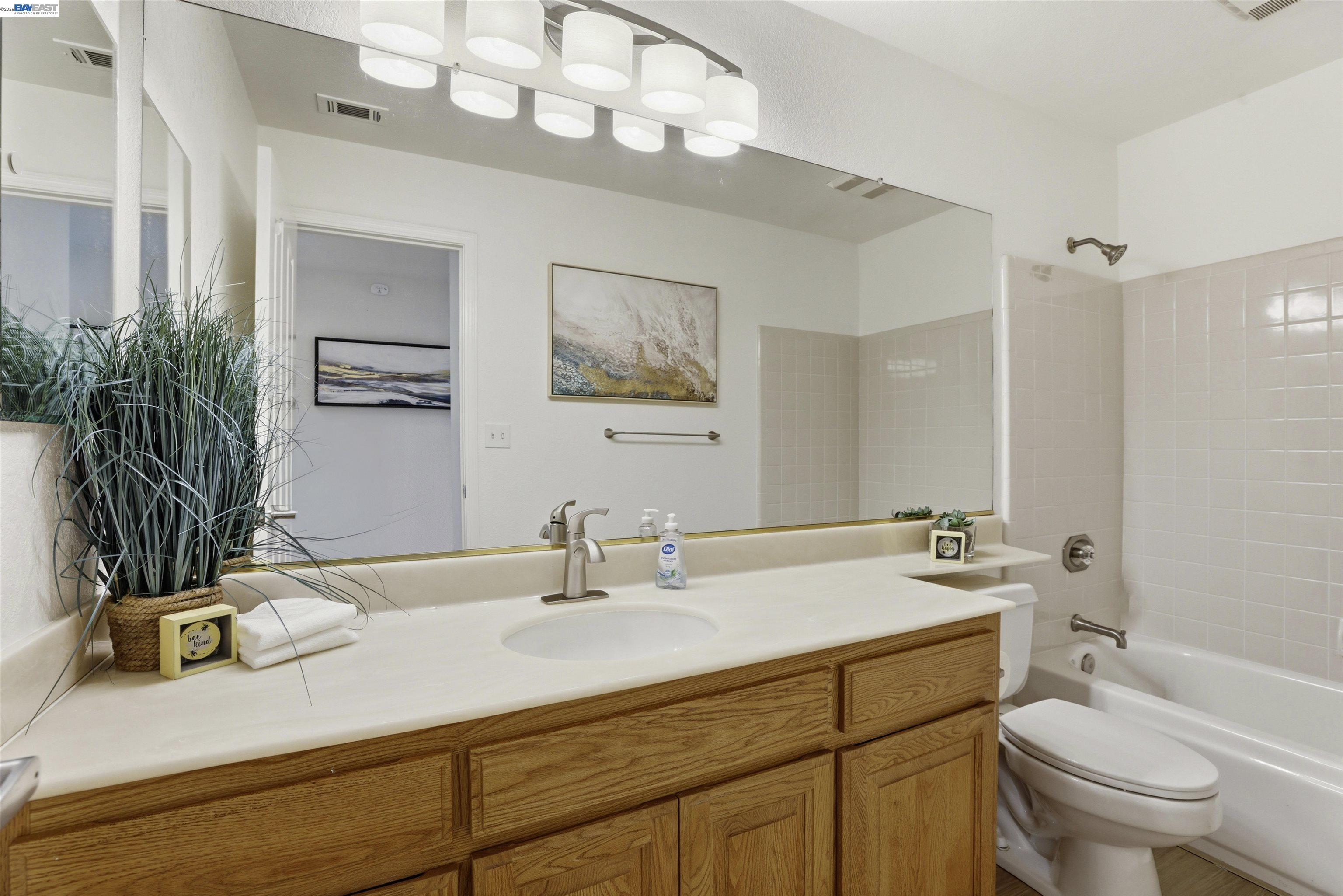 4161 Garibaldi Place Pleasanton, CA 94566 - Photo 34 of 47 a bathroom with a sink a toilet and mirror