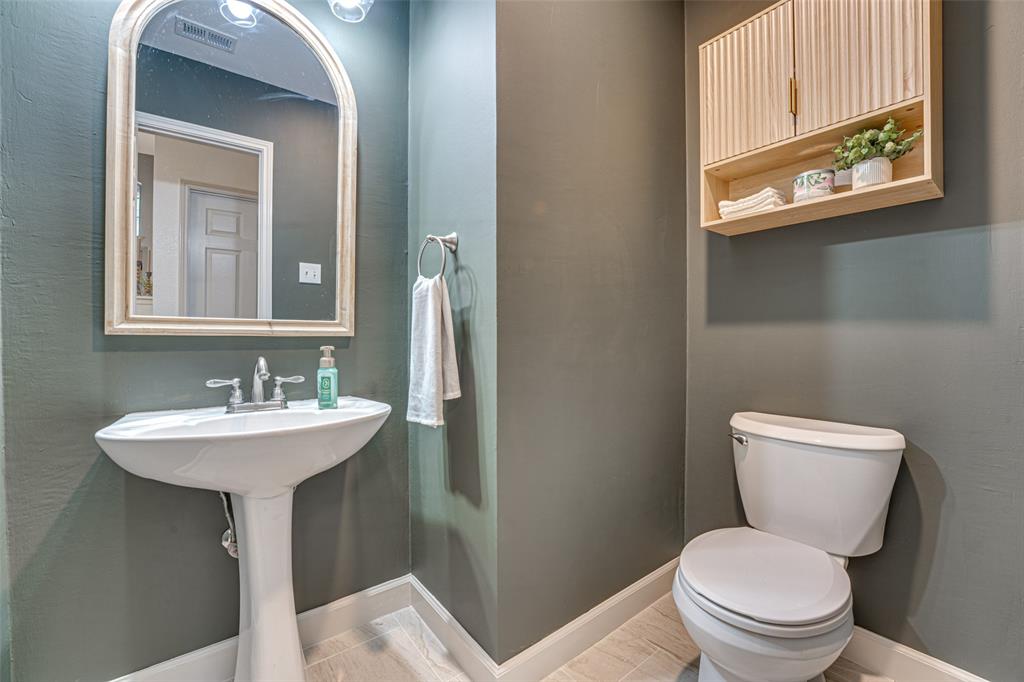 5218 Griffins Pointe Drive Rowlett, TX 75089 - Photo 21 of 40 Half bath with recent paint and lighting.